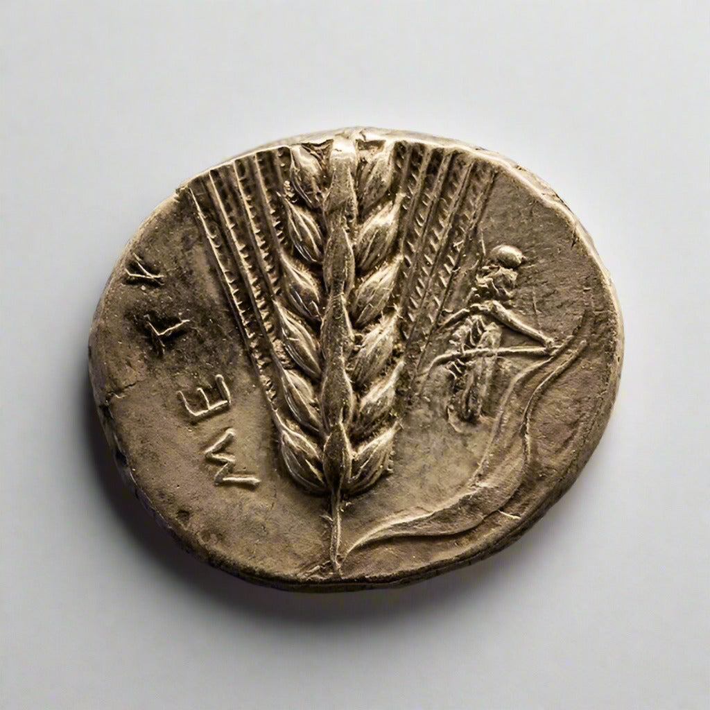Ancient coin with wheat sheaf and personification of Etruria on a textured gray background