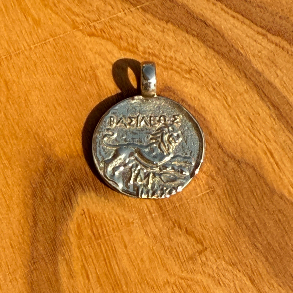 Silver pendant on a wooden surface