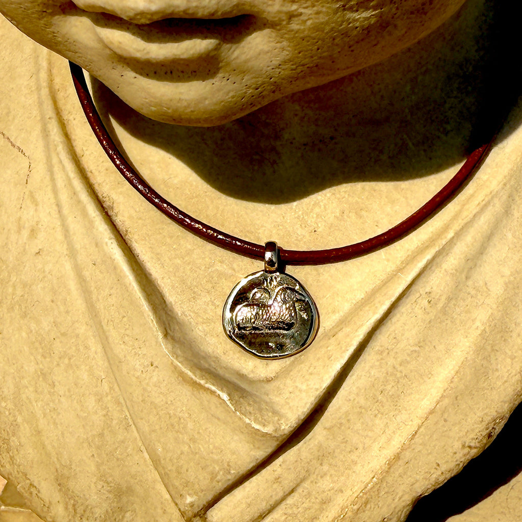 Necklace with a pendant on a stone sculpture