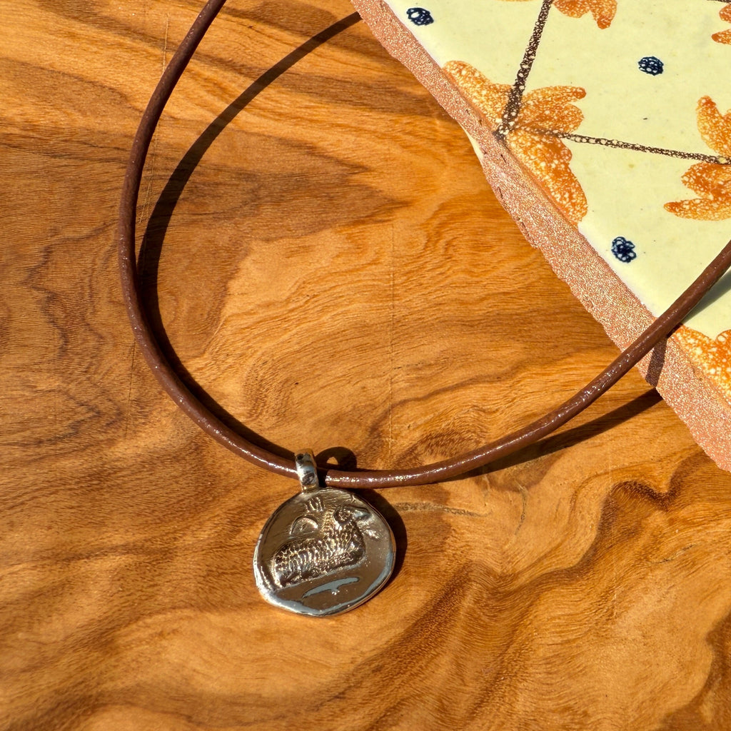 Necklace with a pendant on a wooden surface