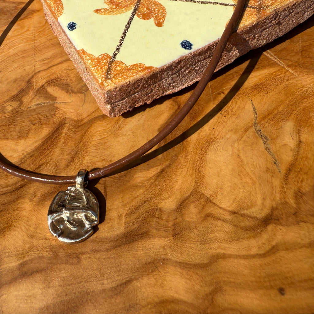 Necklace with a pendant on a wooden surface