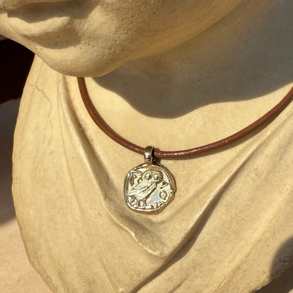 Close-up of a necklace with a pendant on a textured surface