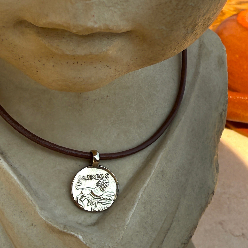 Necklace with a pendant on a stone statue