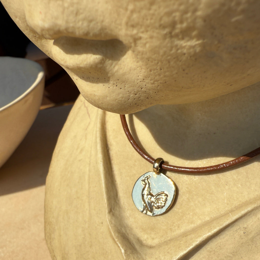 Necklace with a pendant on a beige fabric background