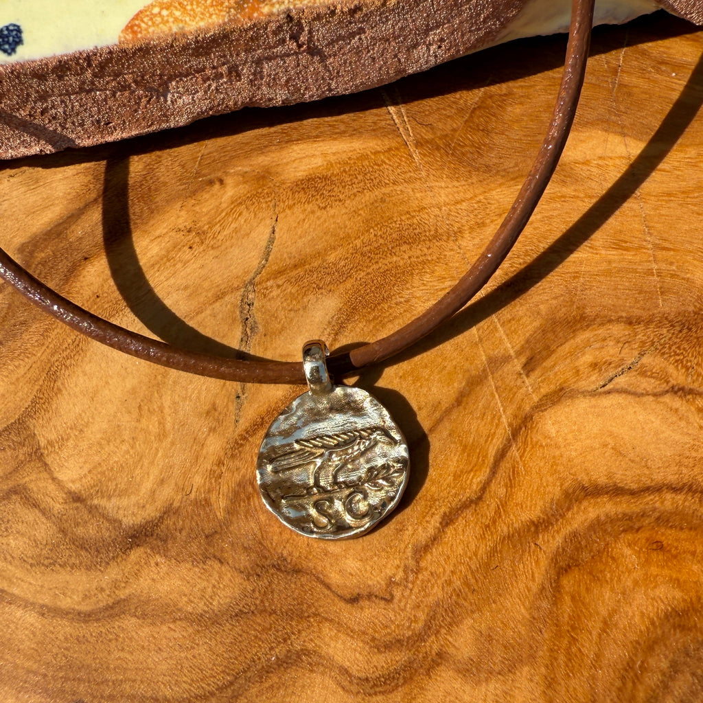 Necklace with a pendant on a wooden surface