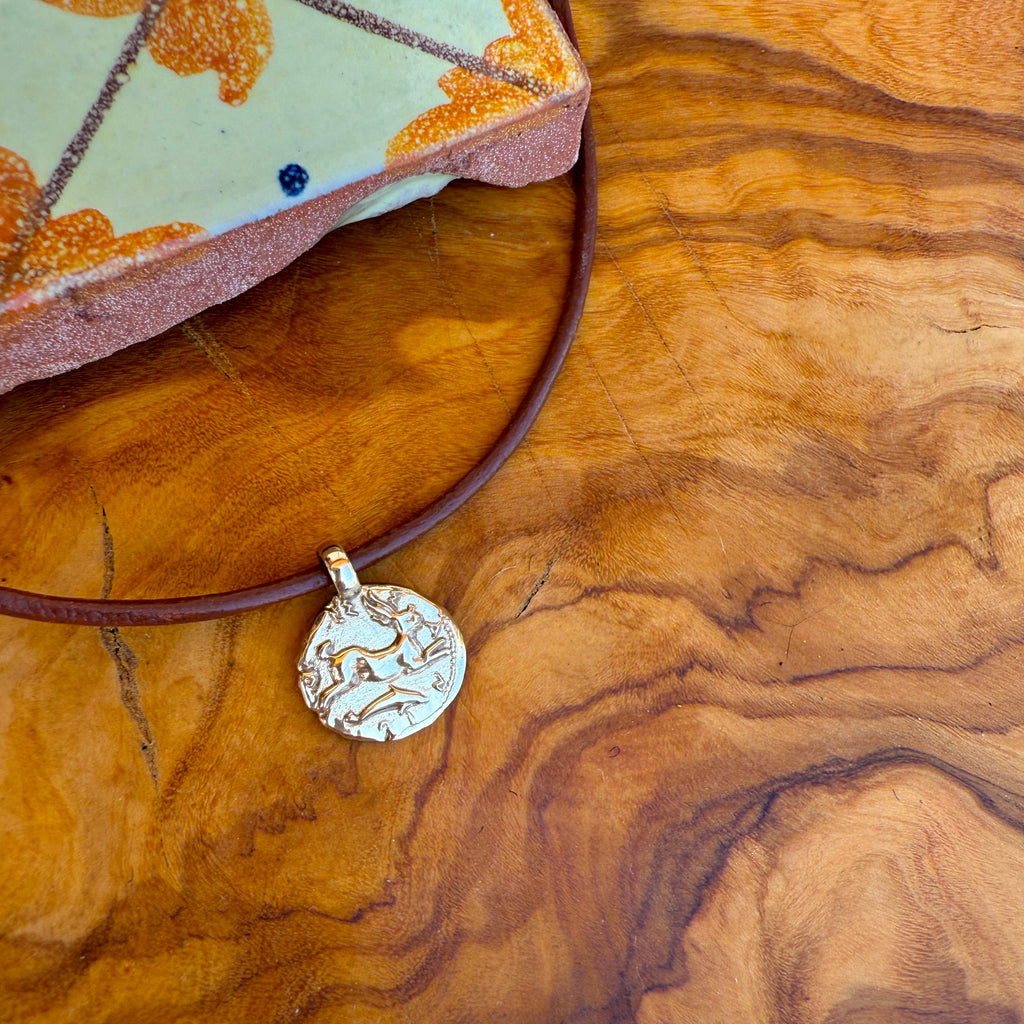 Necklace with a pendant on a wooden surface